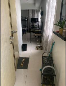 a hallway with a door and a bench in a room at SM North FERN@GRASS RESIDENCES in Manila