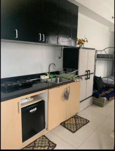 a small kitchen with a sink and a stove at SM North FERN@GRASS RESIDENCES in Manila