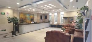 a salon with a waiting room with chairs and a counter at Eryi Hotel in Shanghai