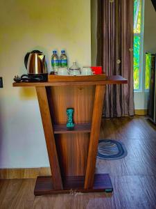 a wooden shelf with items on top of it at Residence Inn in Udawalawe