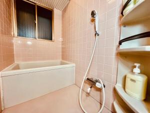 a bathroom with a shower with a sink and a bath tub at 大山町戸建 in Tokyo