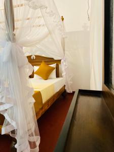a bedroom with a bed with a mosquito net at 682 Villa Weligama in Weligama