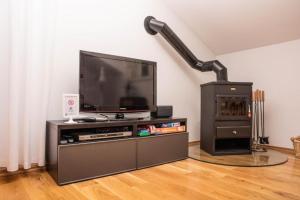 a living room with a flat screen tv on a entertainment center at Apartments Marijin Dvor in Splitska