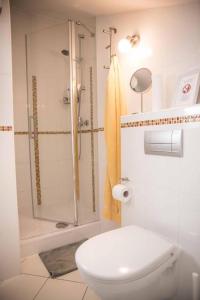 a white bathroom with a shower and a toilet at Apartments Marijin Dvor in Splitska