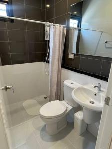 a bathroom with a toilet and a sink at Borbaimai home in Chiang Rai