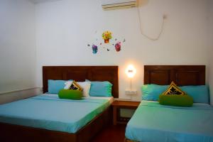 Postel nebo postele na pokoji v ubytování White Villa Hotel