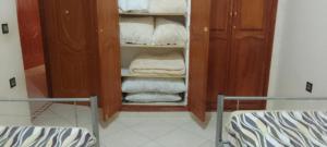a bathroom with a closet filled with towels at Magnifique appartement in Marrakesh