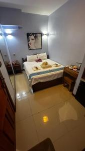 a small bedroom with a bed and a desk at China Lounge in Sihanoukville