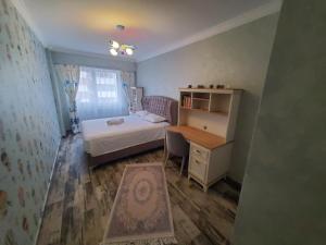 a small bedroom with a bed and a desk at Luxury Apartament Bacovia in Bacău