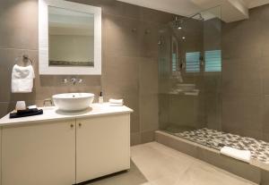 a bathroom with a sink and a shower at Hide-Away Guest House in Knysna