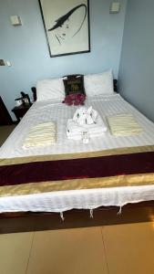 a bed with clothes and towels on it at China Lounge in Sihanoukville