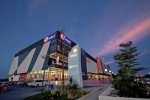 a large building in a parking lot at night at SUMMER SUITES APARTMENT CASETTA HOMESTAY 2 at Kota Samarahan Kuching in Kuching