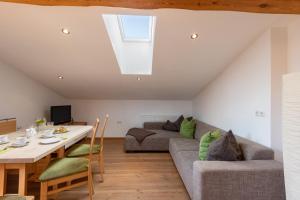 a living room with a couch and a table at Gugg Hof - Familie Hölzl in Hopfgarten im Brixental