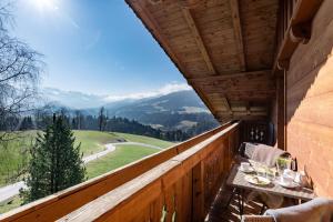 a balcony with a table and a view of mountains at Gugg Hof - Familie Hölzl in Hopfgarten im Brixental