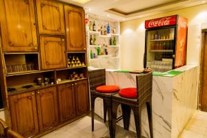 a kitchen with a counter with a table and a cocacola refrigerator at Hotel Everest Regency in Kathmandu