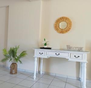 a white console table in a room with a mirror at Nefeli's Home- Family luxury apartment in Heraklio Town