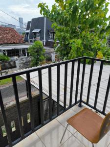 a chair sitting on the balcony of a building at PROMOSIA GUEST HOUSE in Surabaya