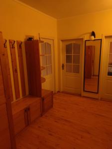 a room with yellow walls and a wooden floor at Apartment in the Levice in Levice