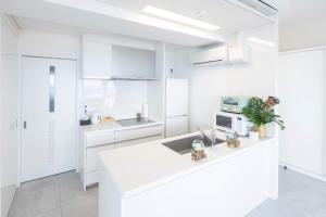 a white kitchen with white cabinets and a sink at MARSOL C,S,Beach hotel - Vacation STAY 50047v in Chigasaki