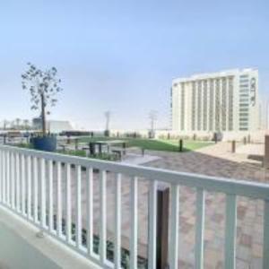 a balcony with a white railing and a building at Key View - Navitas Tower A in ‘Ūd al Bayḑāʼ