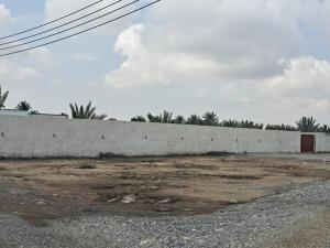 una pared de hormigón frente a un edificio en استراحة قصَّة, en Barka