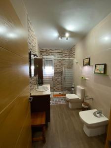 un baño con dos lavabos y dos inodoros en Casa Pepe, en Níjar