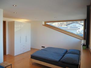 a bedroom with a bed and a large window at Ferienwohnung Böhler in Doren