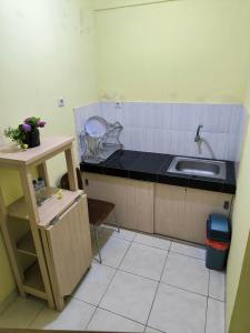 a kitchen with a sink and a counter top at PROMOSIA GUEST HOUSE in Surabaya