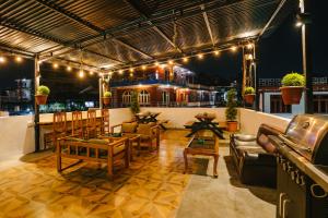 a patio with furniture and lights on a building at Dharma Backpackers in Pokhara