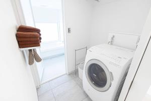 a white laundry room with a washing machine at MARSOL C,S,Beach hotel - Vacation STAY 50798v in Chigasaki