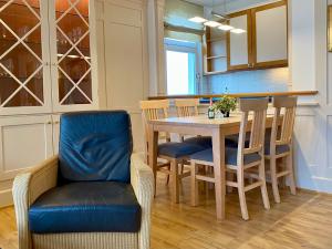 a kitchen with a dining room table and chairs at Villa Usedom App. 31 in Heringsdorf