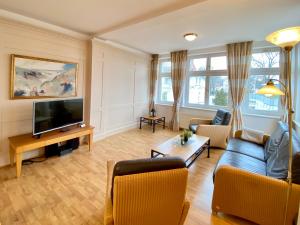 a living room with a couch and a tv at Villa Usedom App. 31 in Heringsdorf