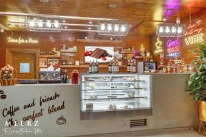 a restaurant with a counter with a bakery at Hotel Meerz , Srinagar in Srinagar