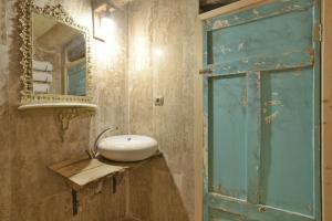 a bathroom with a sink and a mirror at Philosophy Hotel in Uchisar