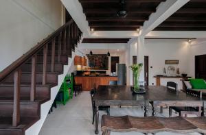 a dining room and kitchen with a table and chairs at Nativ Living Villa Legian 6BR Villa 16px Big Group Walk to 66 Beach in Seminyak