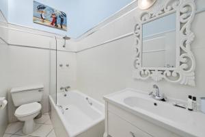a white bathroom with a sink toilet and a mirror at San Lameer Villa 2845 - 3 Bedroom Classic - 6 pax - San Lameer Rental Agency in Southbroom