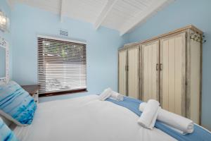a bedroom with a large bed and a window at San Lameer Villa 2845 - 3 Bedroom Classic - 6 pax - San Lameer Rental Agency in Southbroom