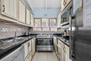 a large kitchen with a stainless steel refrigerator at San Lameer Villa 2845 - 3 Bedroom Classic - 6 pax - San Lameer Rental Agency in Southbroom