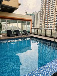 a swimming pool on the roof of a building at hotel in ermita manila birch tower in Manila