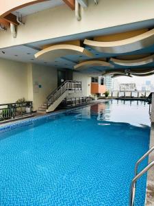 una grande piscina in un edificio con una grande piscina di hotel in ermita manila birch tower a Manila