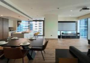 a living room with a table and chairs and a kitchen at Key View - Marina Gate in Dubai