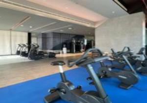 a gym with several cardio bikes in a room at Key View - Marina Gate in Dubai