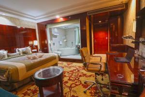 a bedroom with a bed and a bathroom with a tub at SkyCity Hotel Gurgaon in Gurgaon