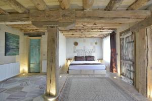 a bedroom with a bed in a room with wooden ceilings at Philosophy Hotel in Uchisar