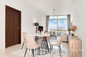 a kitchen and dining room with a table and chairs at LUX - Opulent Island Suite Burj Khalifa View 2 in Dubai