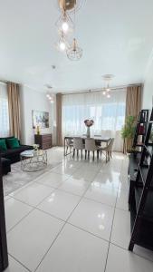 a living room with a table and a dining room at Two Continents Holiday Homes - Marvelous Marina Apartment in Dubai