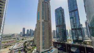 a tall building in a city with tall buildings at Two Continents Holiday Homes - Marvelous Marina Apartment in Dubai