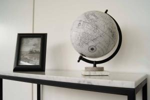 a globe sitting on a table next to a picture at Design Apartment with Amazing Private Terrace in Mexico City