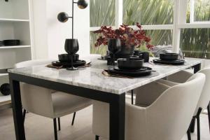 a dining room table with white chairs and a marble table top at Design Apartment with Amazing Private Terrace in Mexico City