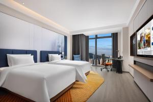 เตียงในห้องที่ Hampton by Hilton Shenzhen Futian Huaqiangbei